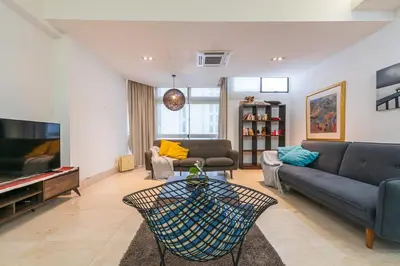 a living room with a couch and a television at Fahrenheit 88 Kuala Lumpur in Kuala Lumpur