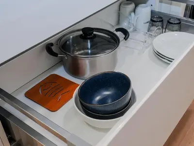 a pot on a stove with some bowls and plates at Star Premier KLCC Suite 3-4pax by LavishHome in Kuala Lumpur