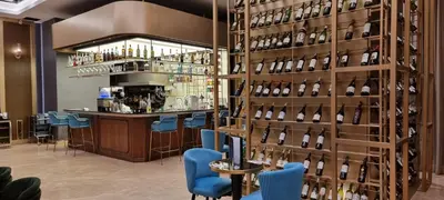 a bar with a wall of wine bottles at Star Premier KLCC Suite 3-4pax by LavishHome in Kuala Lumpur