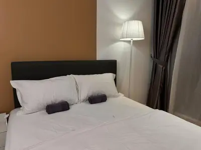 a white bed with two pillows and a lamp at KLCC view cozy studio apartment Trion C243A KL in Kuala Lumpur