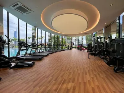 a gym with a row of treadmills and ellipticals at KLCC view cozy studio apartment Trion C243A KL in Kuala Lumpur