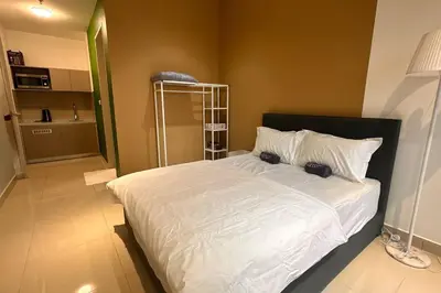 a bedroom with a large bed with white sheets and pillows at KLCC view cozy studio apartment Trion C243A KL in Kuala Lumpur