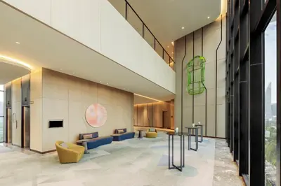 a lobby with couches and chairs in a building at Holiday Inn Kuala Lumpur Bangsar by IHG in Kuala Lumpur