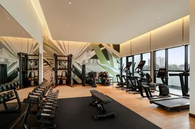 a gym with a bunch of treadmills and exercise equipment at Holiday Inn Kuala Lumpur Bangsar by IHG in Kuala Lumpur