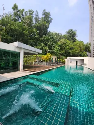 a swimming pool with blue water in front of a building at KL Dorsett Damas Grandeur Suite-F-Parking, Self C-In in Kuala Lumpur
