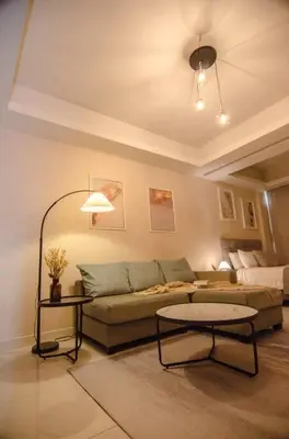 a living room with a couch and a table at KL Dorsett Damas Grandeur Suite-F-Parking, Self C-In in Kuala Lumpur