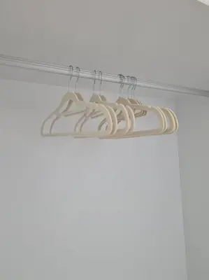 a group of white hangers on a shelf at KL View 3BedRoom 2carpark MRT Station Cheras Maluri FreeWifi C41 in Kuala Lumpur