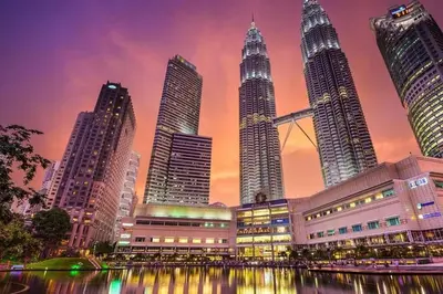 a city skyline with tall skyscrapers at sunset at Bintang Fairlane Residence, Cozy Fam Suite with Bathtub - 2B2R in Kuala Lumpur