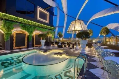 a swimming pool with chairs and a building at Arte Mont Kiara in Kuala Lumpur