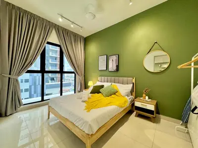 a bedroom with green walls and a bed with a yellow blanket at 2R2B Chan Sow Lin Trion 2 - 6 pax in Kuala Lumpur