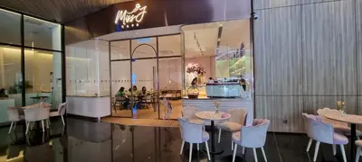 a restaurant with tables and chairs in a building at Star Superior KLCC Suite 4-5pax by LavishHome in Kuala Lumpur