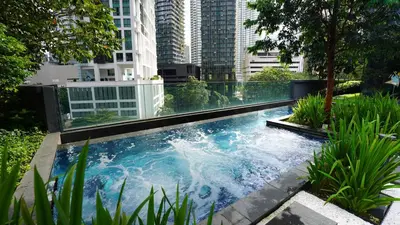 a swimming pool in the middle of a city at Star Superior KLCC Suite 4-5pax by LavishHome in Kuala Lumpur