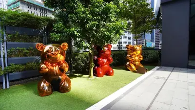 four statues of teddy bears sitting on the grass at Star Superior KLCC Suite 4-5pax by LavishHome in Kuala Lumpur