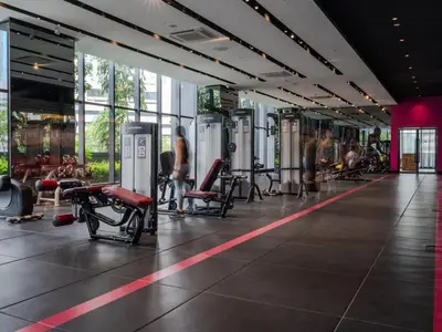 a gym with chairs and people exercising in it at Star Superior KLCC Suite 4-5pax by LavishHome in Kuala Lumpur