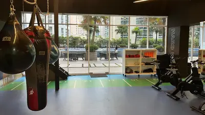 a gym with two punching bags and weights at City Centre KLCC in Kuala Lumpur