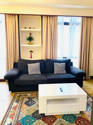 a living room with a blue couch and a white coffee table at Unique Suite Times Square at Bukit Bintang Kuala Lumpur in Kuala Lumpur