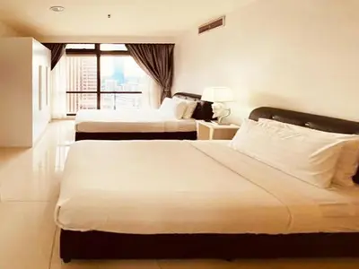a hotel room with two beds and a window at Unique Suite Times Square at Bukit Bintang Kuala Lumpur in Kuala Lumpur