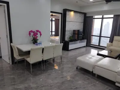 a living room with a table and chairs and a couch at Times Square Super Suites at Bukit Bintang KL in Kuala Lumpur