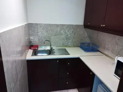 a small kitchen with a sink and a counter at Times Square Super Suites at Bukit Bintang KL in Kuala Lumpur
