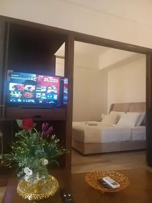 a living room with a television and a couch at Times Square Super Suites at Bukit Bintang KL in Kuala Lumpur