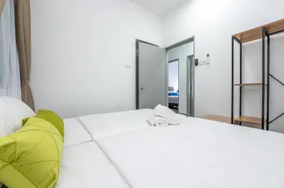 a bedroom with a white bed with a yellow blanket at 5min to KL TRX Bukit Bintang for 6paxs in Kuala Lumpur