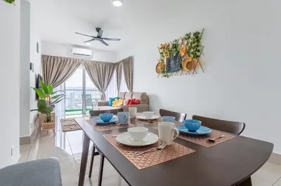 a dining room with a table with chairs and a couch at 5min to KL TRX Bukit Bintang for 6paxs in Kuala Lumpur