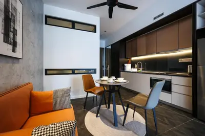 a living room with a couch and a table at Scarletz Suites KLCC by GB in Kuala Lumpur