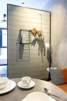 a table with two cups and a bird cage at Scarletz Suites KLCC by GB in Kuala Lumpur