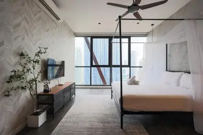 a bedroom with a bed and a ceiling fan at Scarletz Suites KLCC by GB in Kuala Lumpur