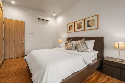 a bedroom with a large white bed and two lamps at Fahrenheit 88 Pavillion Bukit Bintang 3 bedroom in Kuala Lumpur