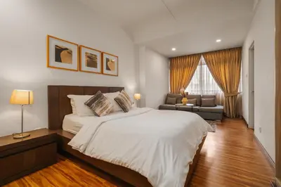 a bedroom with a large bed and a couch at Fahrenheit 88 Pavillion Bukit Bintang 3 bedroom in Kuala Lumpur