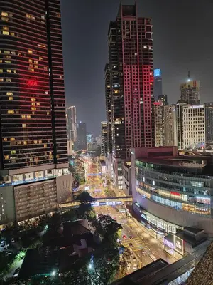 a city skyline with tall buildings and traffic at night at Comfy Stay at Wisma Cosway Pavilion KLCC Bukit Bintang in Kuala Lumpur