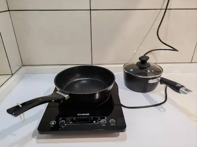 a pot sitting on top of a stove at M 2-7pax 200mbpswifi near Mrt Lrt HKL IJN in Kuala Lumpur