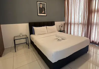 a bedroom with a large bed with white sheets at robertson by katie suites in Kuala Lumpur