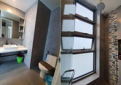 a bathroom with a toilet and a sink and a window at robertson by katie suites in Kuala Lumpur