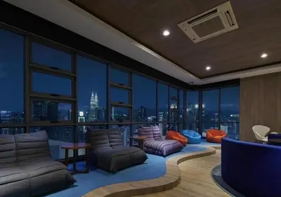 a living room with a view of a city at robertson by katie suites in Kuala Lumpur