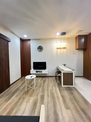 a living room with a tv and a desk at Parkview Service Apartment By Bonjour in Kuala Lumpur