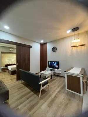 a living room with a couch and a tv at Parkview Service Apartment By Bonjour in Kuala Lumpur