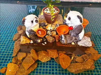 two stuffed animals are sitting on a tray with rocks at Regalia Residence by Luvit Stay in Kuala Lumpur