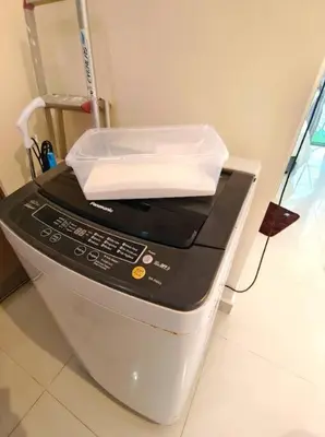 a remote control sitting on top of a machine at Regalia Residence by Luvit Stay in Kuala Lumpur