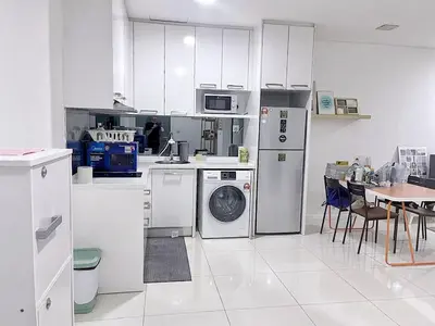a kitchen with white appliances and a table with chairs at KL CITY CENTRE nearby KLCC in Kuala Lumpur