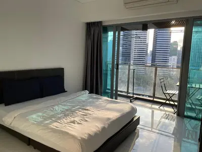 a bedroom with a bed and a balcony with a view at KL CITY CENTRE nearby KLCC in Kuala Lumpur