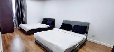 a bedroom with two beds with blue pillows at KL CITY CENTRE nearby KLCC in Kuala Lumpur