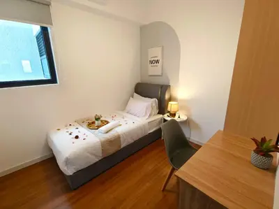 a bedroom with a bed and a table and a window at M-Vertica Sunway Velocity Cheras by Luvit Stay in Kuala Lumpur