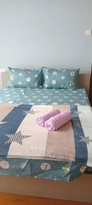a bed with a blanket and pillows on it at Regalia Suite 12-13 in Kuala Lumpur