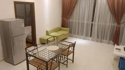 a living room with a table and chairs and a couch at Regalia Suite 12-13 in Kuala Lumpur