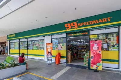 a woman sitting in front of a grocery store at Trion KL by Dreamcloud Sdn Bhd in Kuala Lumpur