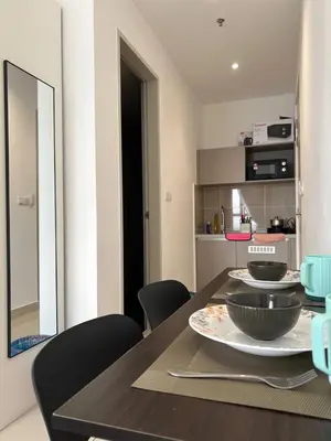 a dining room with a table with bowls on it at Trion KL by Dreamcloud Sdn Bhd in Kuala Lumpur