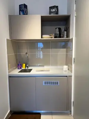 a small kitchen with a sink and a counter at Trion KL by Dreamcloud Sdn Bhd in Kuala Lumpur