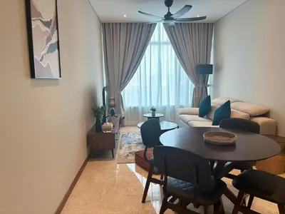 a living room with a table and a couch at SkySuites Luxury Suite By CalmSojourn in Kuala Lumpur
